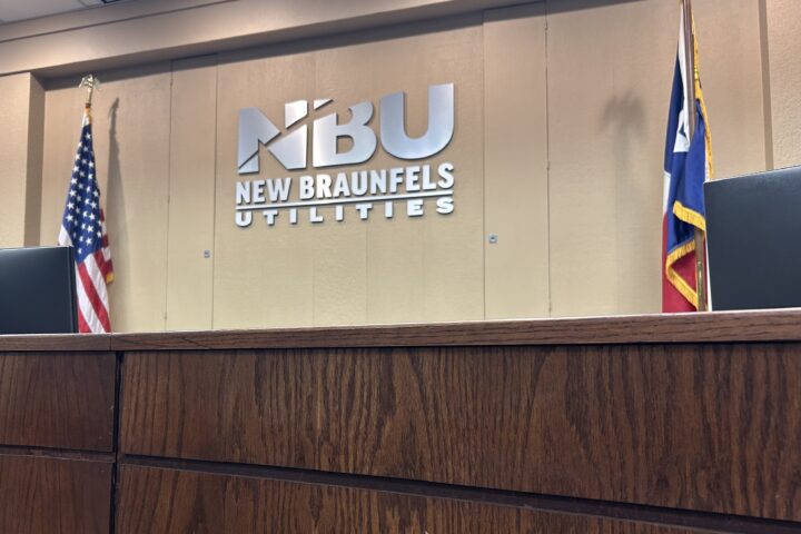 Picture of NBUs Boardroom with the NBU logo on the wall.