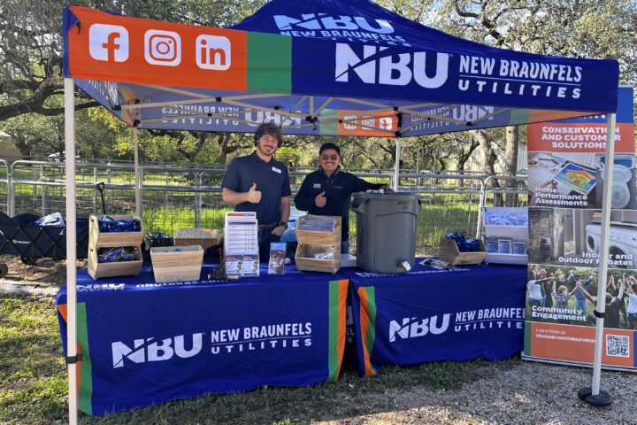 NBU employees set up behind a booth ready t talk about conservation
