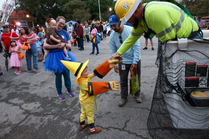 NBU Lineman hands child gloves to try on.